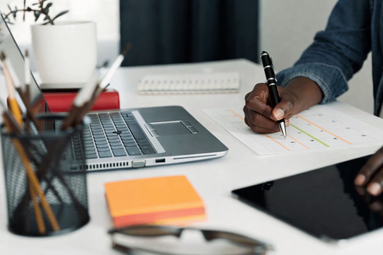 A hiring team reviewing work plans and applications at a desk